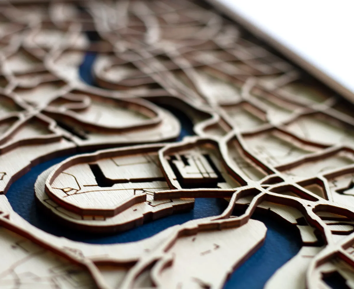 Close detail of layered, laser-cut wood streets and water
